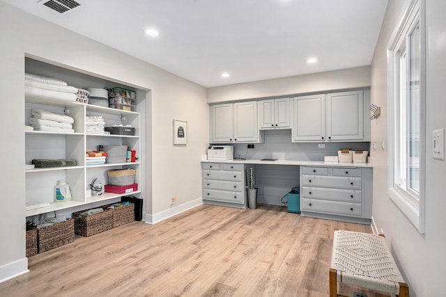 office featuring light wood-style floors, baseboards, visible vents, and recessed lighting