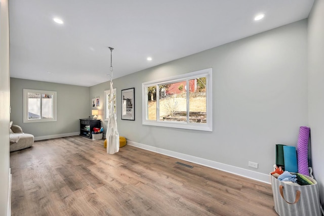 interior space featuring recessed lighting, visible vents, baseboards, and wood finished floors