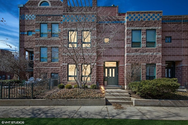 multi unit property with brick siding and fence