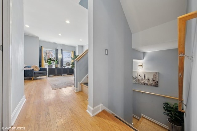 hallway with recessed lighting, baseboards, stairs, and hardwood / wood-style flooring