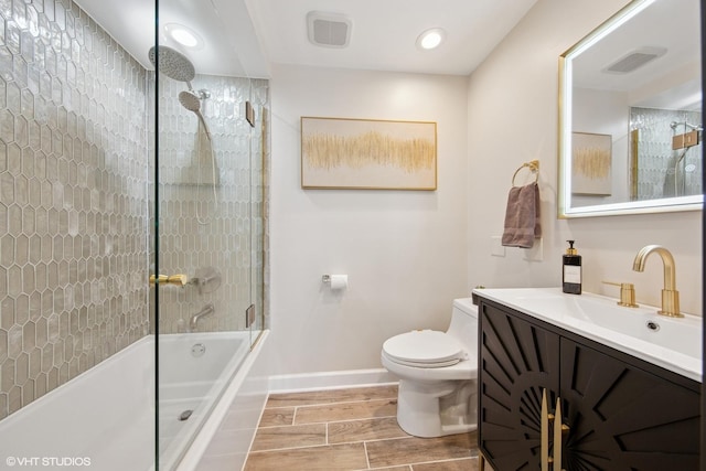 bathroom featuring toilet, baseboards, visible vents, and wood tiled floor