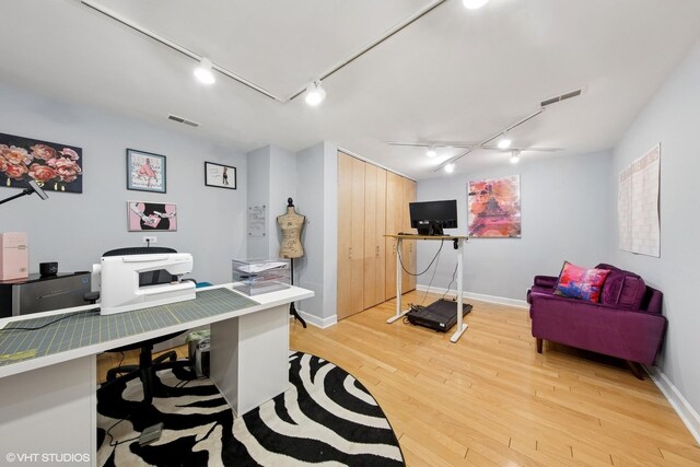 office space with visible vents, light wood-type flooring, and baseboards