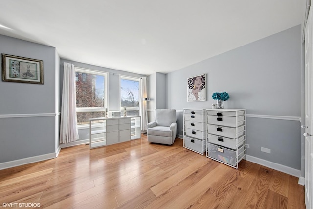 unfurnished room featuring baseboards and light wood-style floors