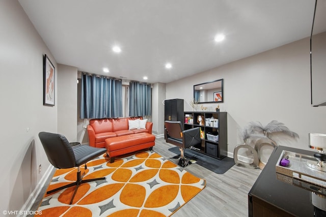 living area with recessed lighting, baseboards, and wood finished floors