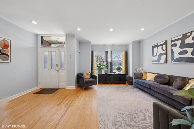 living area with recessed lighting, light wood-type flooring, and ornamental molding