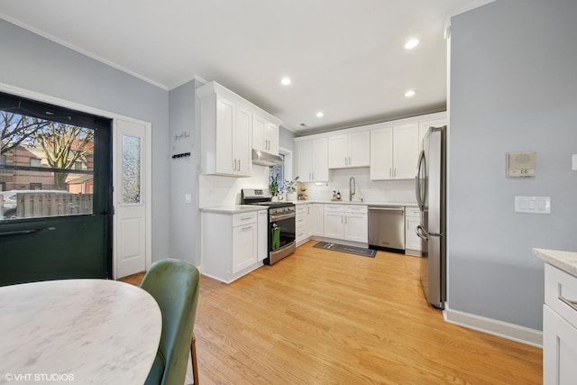 kitchen featuring light wood-type flooring, under cabinet range hood, white cabinetry, stainless steel appliances, and light countertops