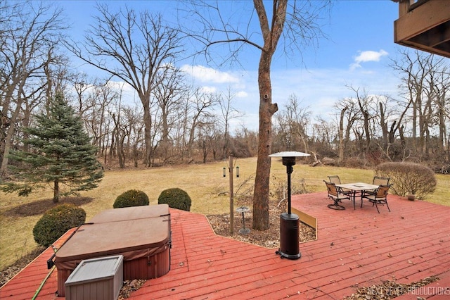 wooden deck featuring outdoor dining area, a yard, a covered hot tub, and a patio area