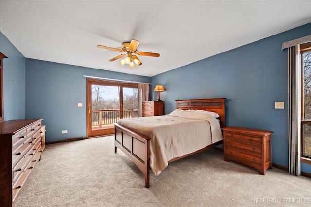 carpeted bedroom with access to exterior, visible vents, baseboards, and a ceiling fan