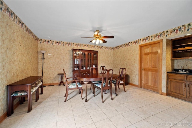 dining room with wallpapered walls, light tile patterned floors, a ceiling fan, and baseboards