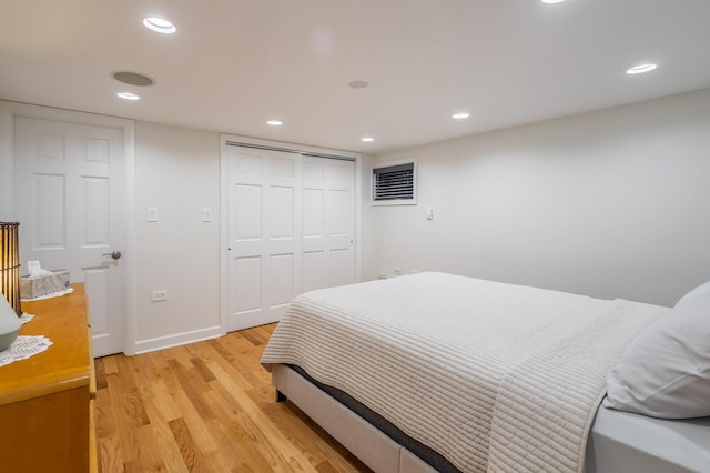 bedroom with recessed lighting, a closet, baseboards, and light wood finished floors