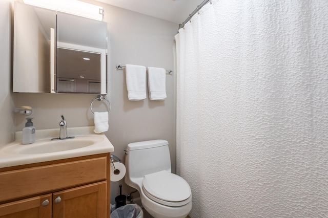 full bath featuring vanity and toilet