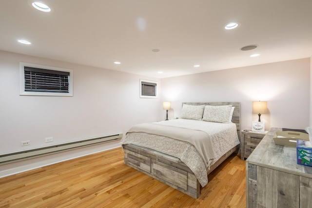 bedroom with a baseboard heating unit, recessed lighting, and light wood finished floors