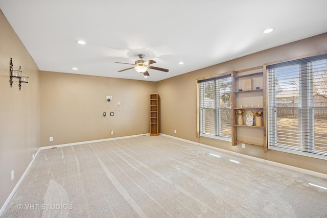 unfurnished room with recessed lighting, light colored carpet, baseboards, and a ceiling fan