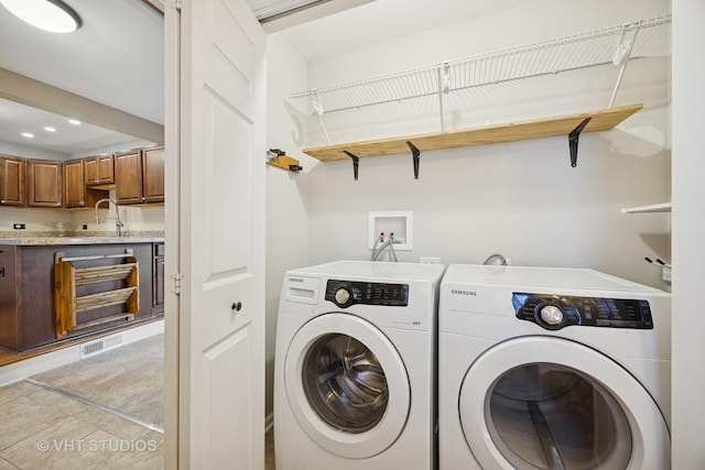 laundry room featuring visible vents, washer and dryer, a sink, recessed lighting, and laundry area