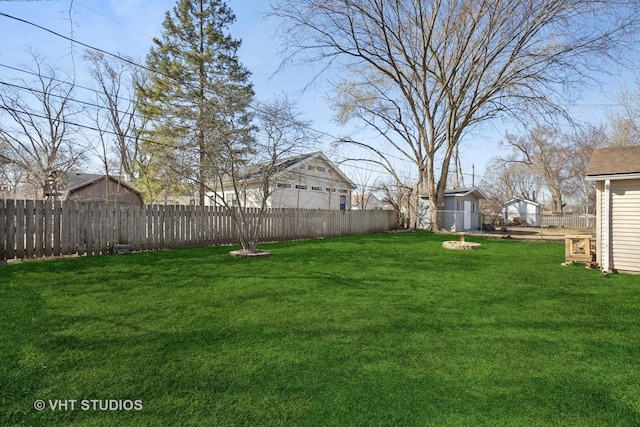 view of yard featuring an outdoor structure and a fenced backyard