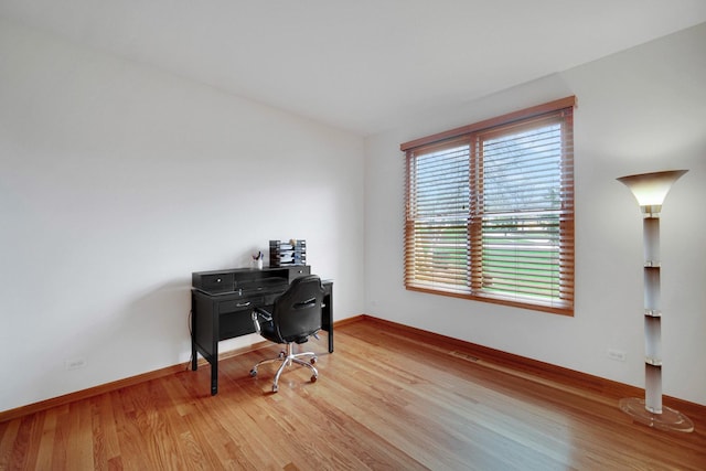 office space featuring light wood-style flooring and baseboards