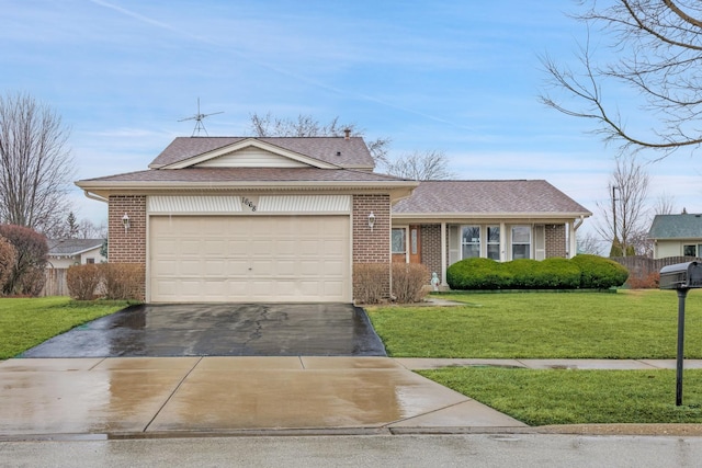 view of front of property with brick siding, a garage, driveway, and a front lawn