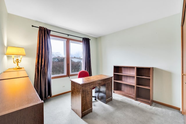 carpeted office space featuring baseboards