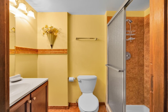 full bath with baseboards, toilet, a stall shower, and vanity