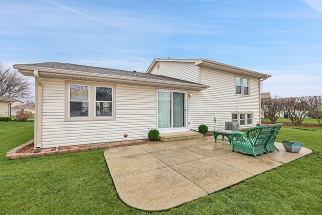 rear view of property featuring a yard, central air condition unit, and a patio