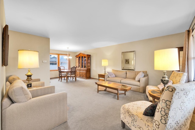 carpeted living area featuring an inviting chandelier