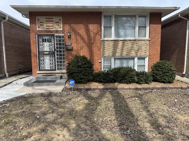 view of exterior entry with brick siding