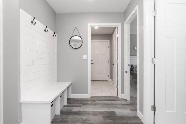 mudroom featuring baseboards and wood finished floors