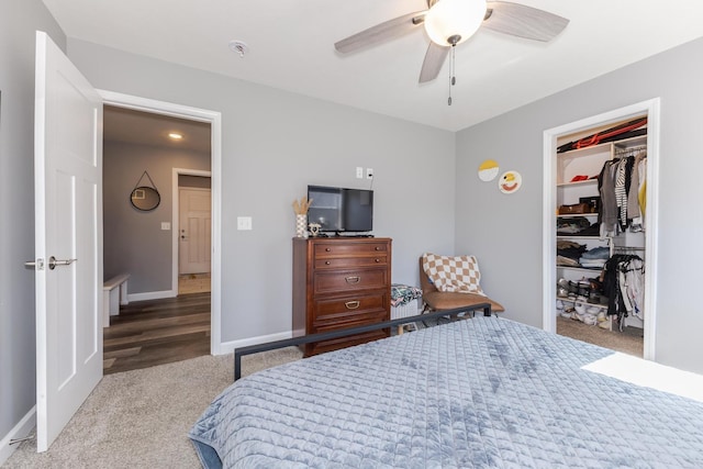 bedroom with a closet, baseboards, ceiling fan, and carpet flooring