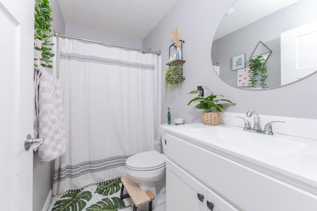 full bathroom with vanity, a shower with shower curtain, and toilet