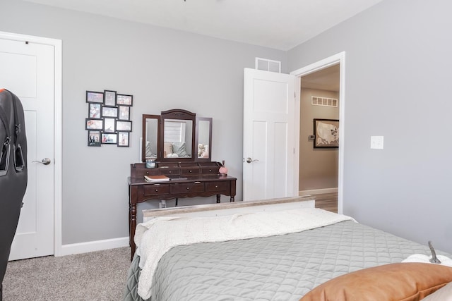 bedroom with visible vents, baseboards, and carpet floors