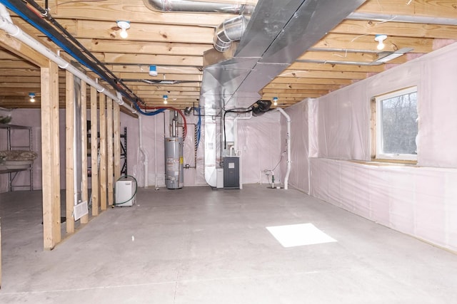 basement featuring heating unit and water heater