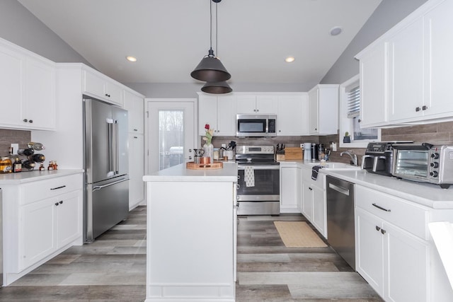 kitchen featuring a wealth of natural light, a kitchen island, appliances with stainless steel finishes, and a toaster