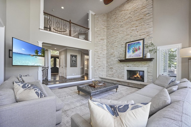 living room with baseboards, wood finished floors, and a fireplace