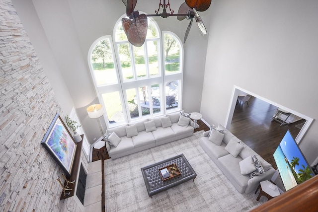 living room with a healthy amount of sunlight and a towering ceiling