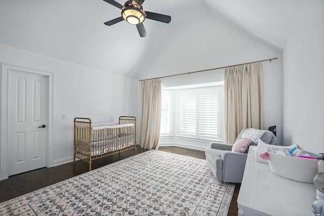 bedroom featuring a nursery area, lofted ceiling, and wood finished floors