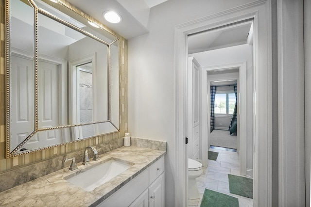 bathroom featuring vanity and toilet