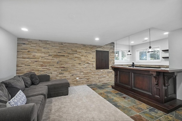 living area with recessed lighting and stone finish flooring