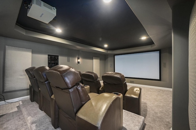 carpeted home theater room with recessed lighting, baseboards, and a tray ceiling