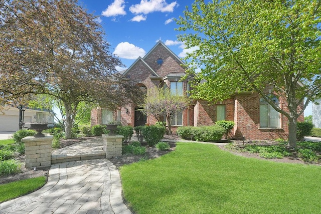 view of front of property featuring brick siding and a front yard