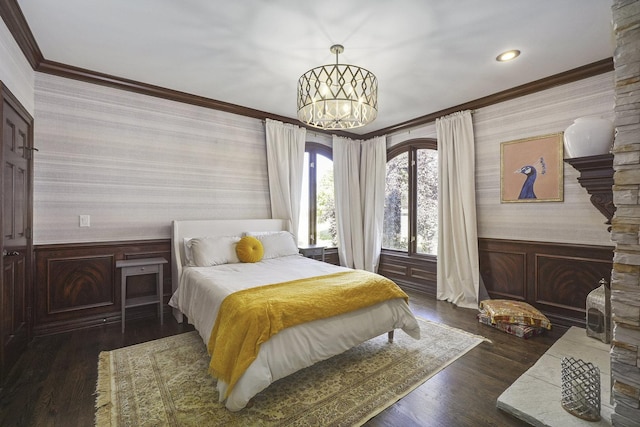 bedroom featuring wallpapered walls, crown molding, and wainscoting