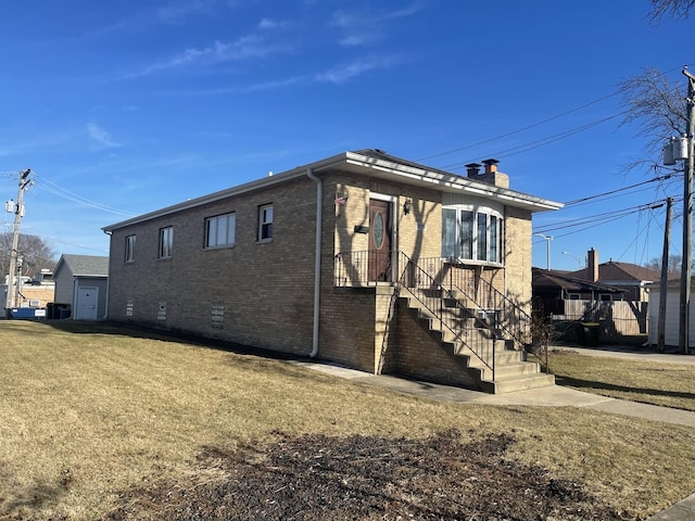 view of side of property featuring a chimney, crawl space, stairs, a yard, and brick siding