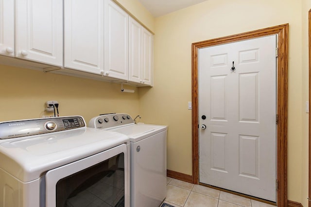 washroom featuring light tile patterned flooring, cabinet space, independent washer and dryer, and baseboards