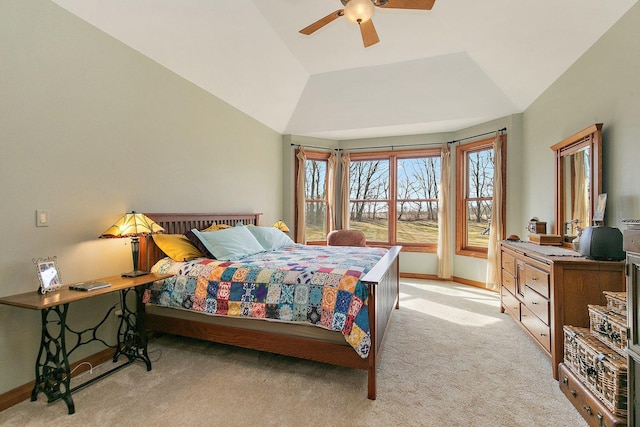 bedroom featuring baseboards, light colored carpet, a ceiling fan, and vaulted ceiling