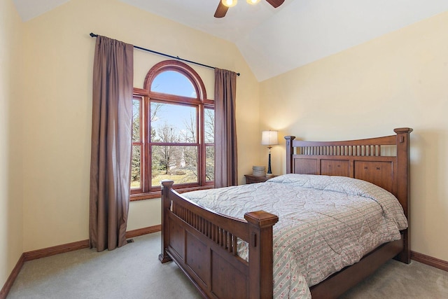 bedroom with baseboards, lofted ceiling, light carpet, and ceiling fan