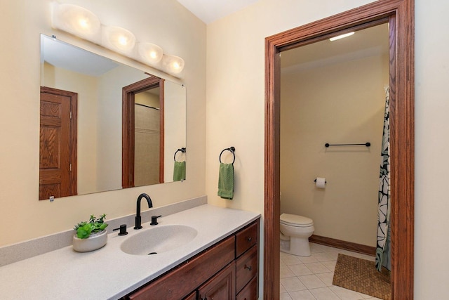 full bathroom with tile patterned flooring, toilet, vanity, and baseboards