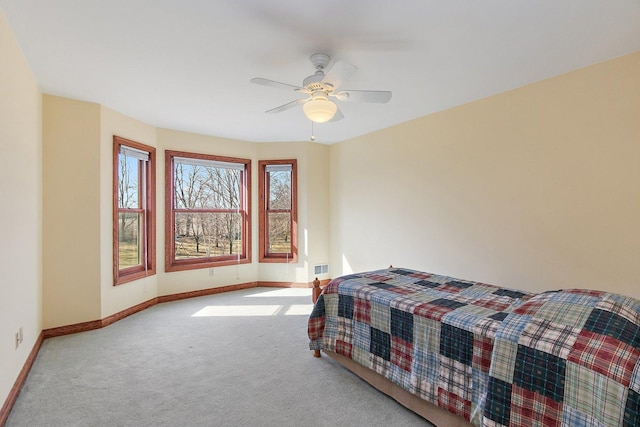 bedroom with a ceiling fan, baseboards, and carpet floors