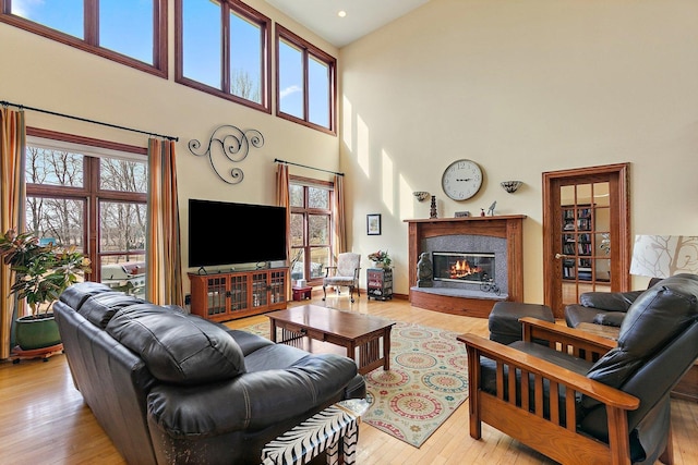 living room with light wood finished floors and a premium fireplace