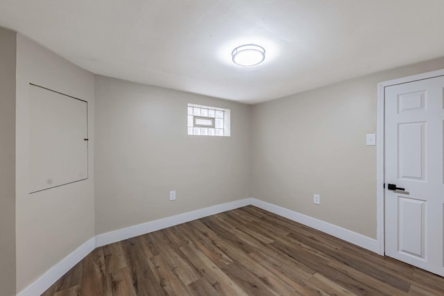 unfurnished room featuring baseboards and wood finished floors