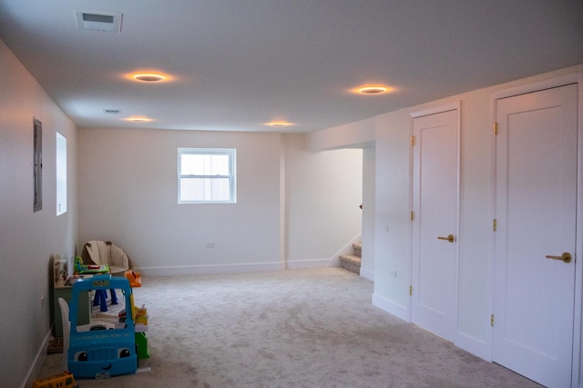 recreation room with baseboards, visible vents, and carpet flooring