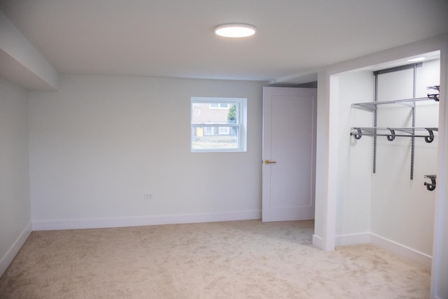 unfurnished bedroom with light carpet and baseboards